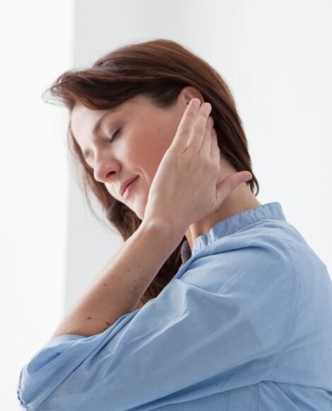 Woman holding her ear and neck in pain