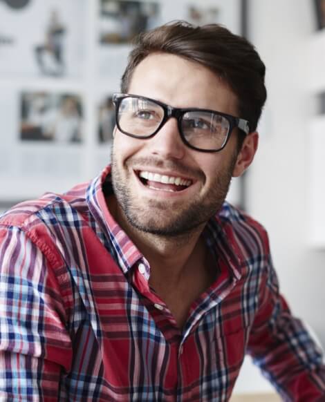 Smiling man in glasses and red plaid shirt