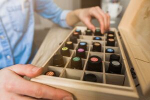 Person standing in front of a box of essential oils